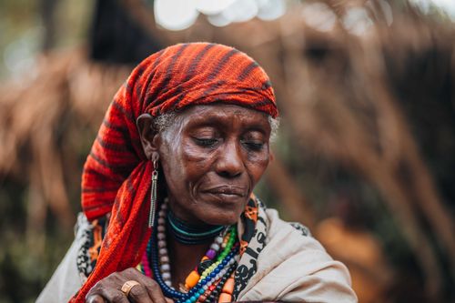 Free Close-up of an elderly woman wearing colorful traditional headscarf and jewelry. Stock Photo