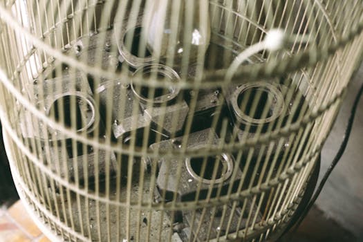 Industrial metal parts stored in a circular cage, highlighting intricate design and structure.