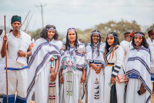 Free A group of Ethiopian adults in traditional white clothing at an outdoor gathering. Stock Photo