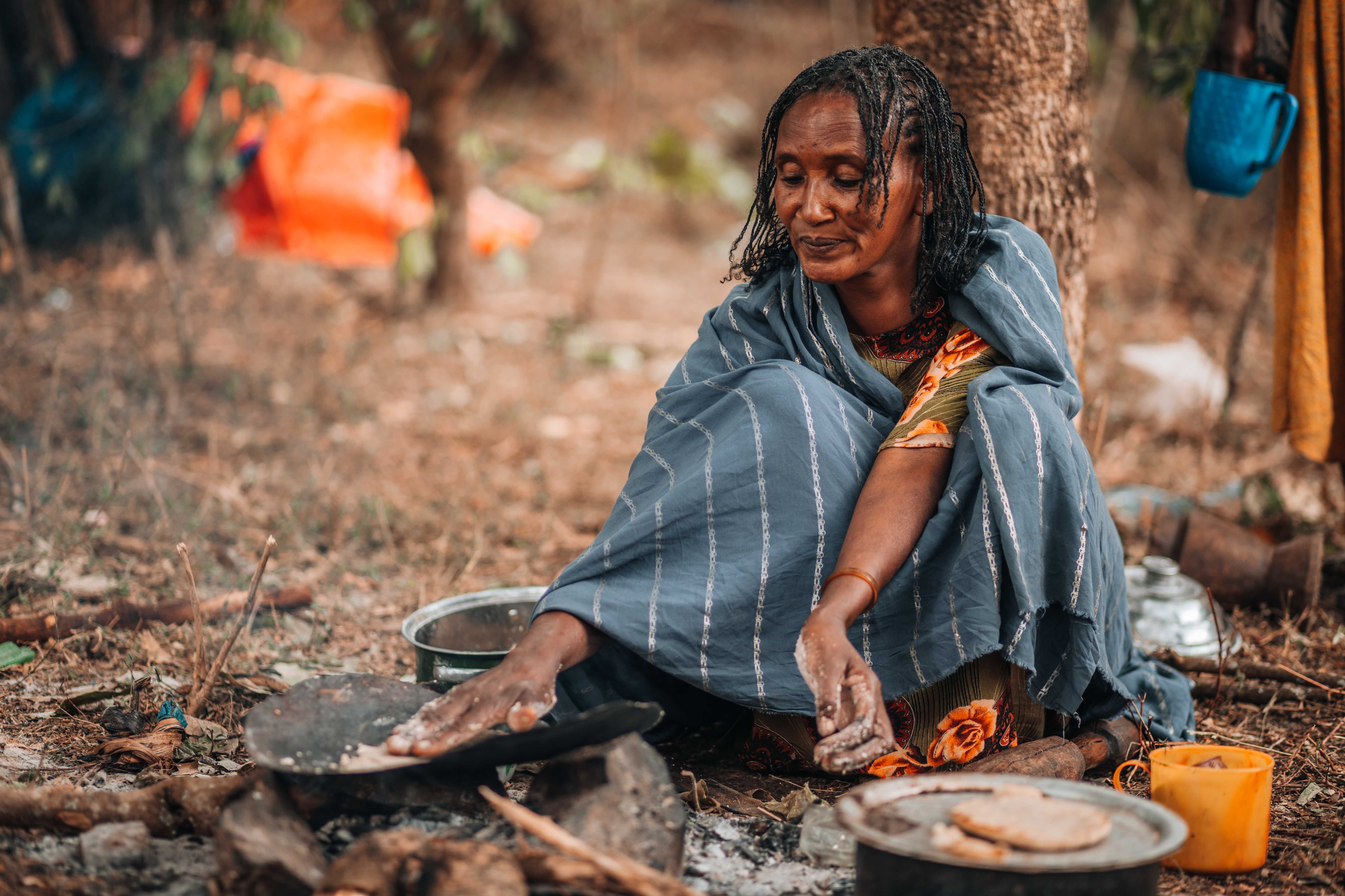 Woman sitting and preparing food, Ethiopia