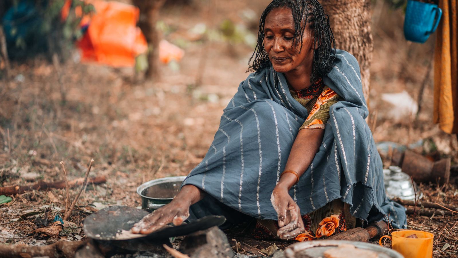 Woman sitting and preparing food, Ethiopia