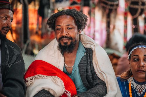 Free A thoughtful portrait of a man dressed in traditional clothing at a vibrant cultural gathering. Stock Photo