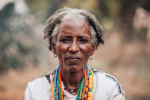 Free Close-up portrait of an elderly African woman wearing colorful traditional necklaces. Stock Photo