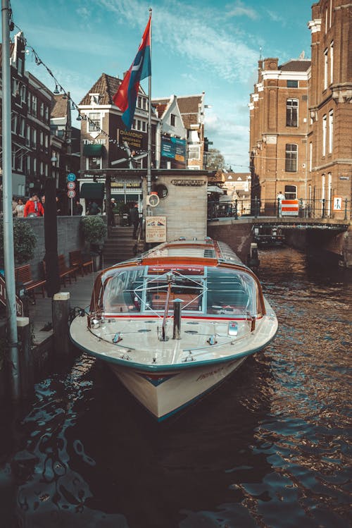 A boat is parked in the water near a building