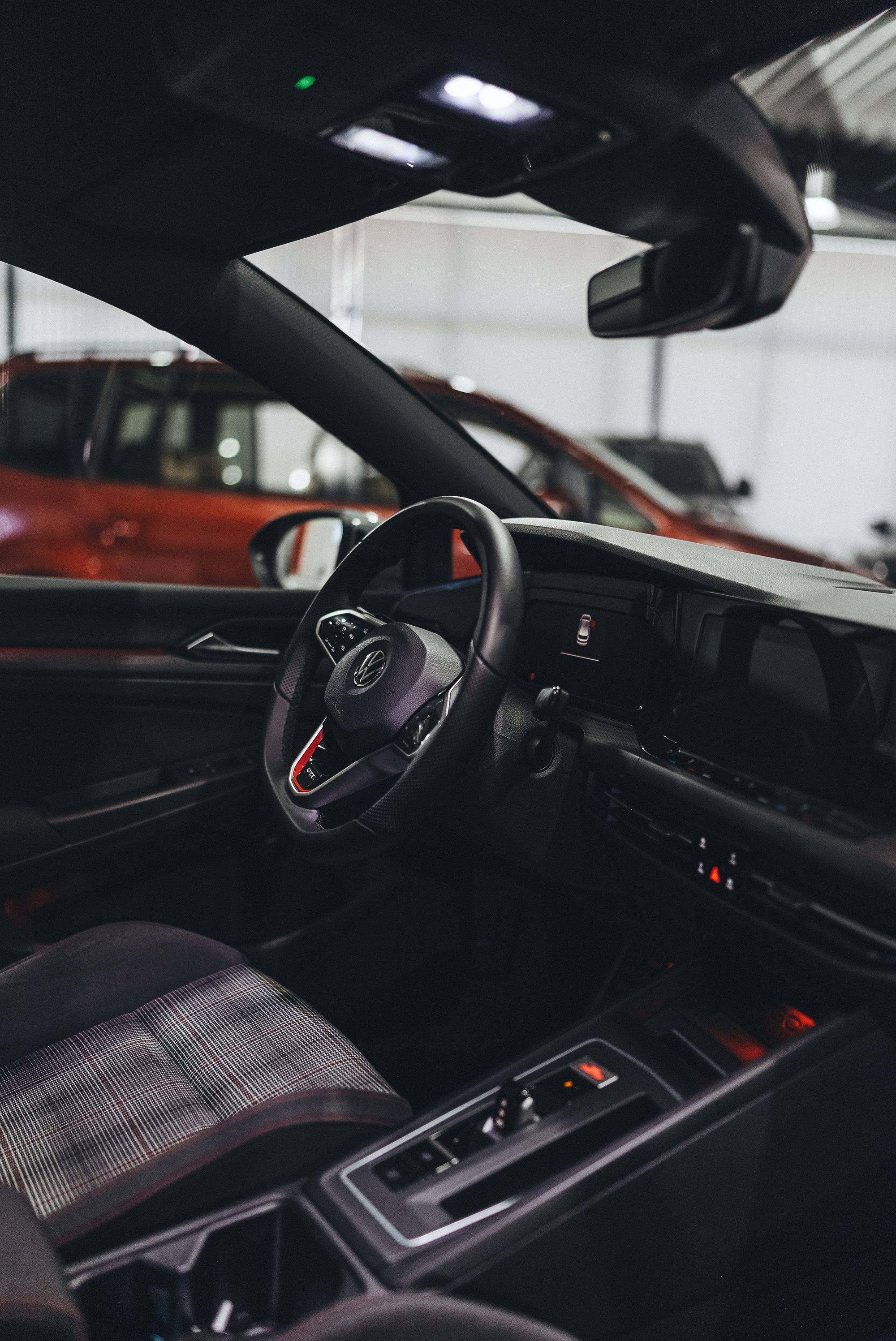 Modern vehicle cabin showing steering wheel and dashboard