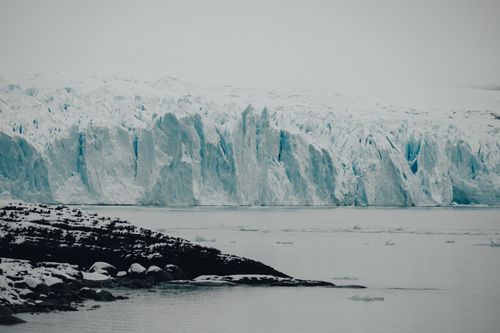 Free A breathtaking view of a glacier meeting the sea, showcasing natural beauty and climate change impacts. Stock Photo