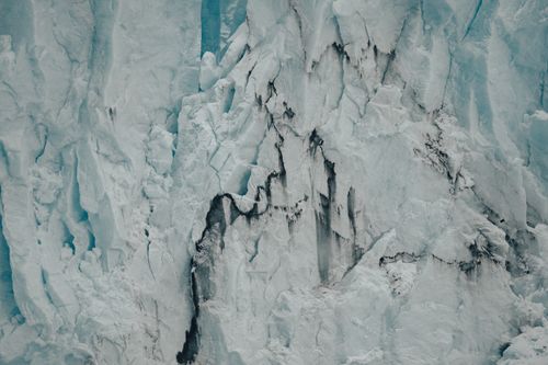 Free Close-up view of a rugged glacier ice cliff, showcasing nature's icy magnificence. Stock Photo