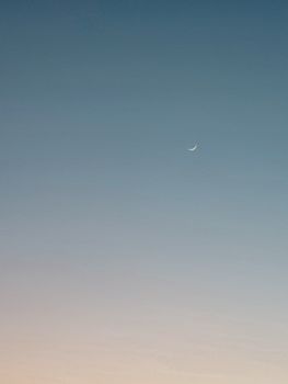 A peaceful crescent moon against a gradient twilight sky. Ideal for backgrounds and calming visuals.