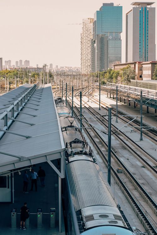 Free Urban train station with modern skyscrapers in the background, depicting urban transportation. Stock Photo