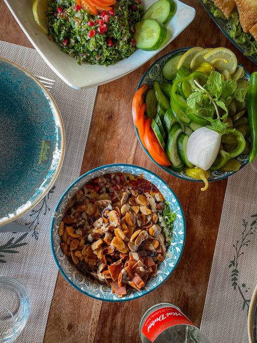 Free Vibrant spread of Middle Eastern dishes with fresh vegetables and nuts. Stock Photo
