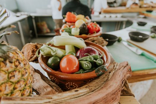 A vibrant collection of fresh vegetables in a rustic kitchen setting, ready for prepping.