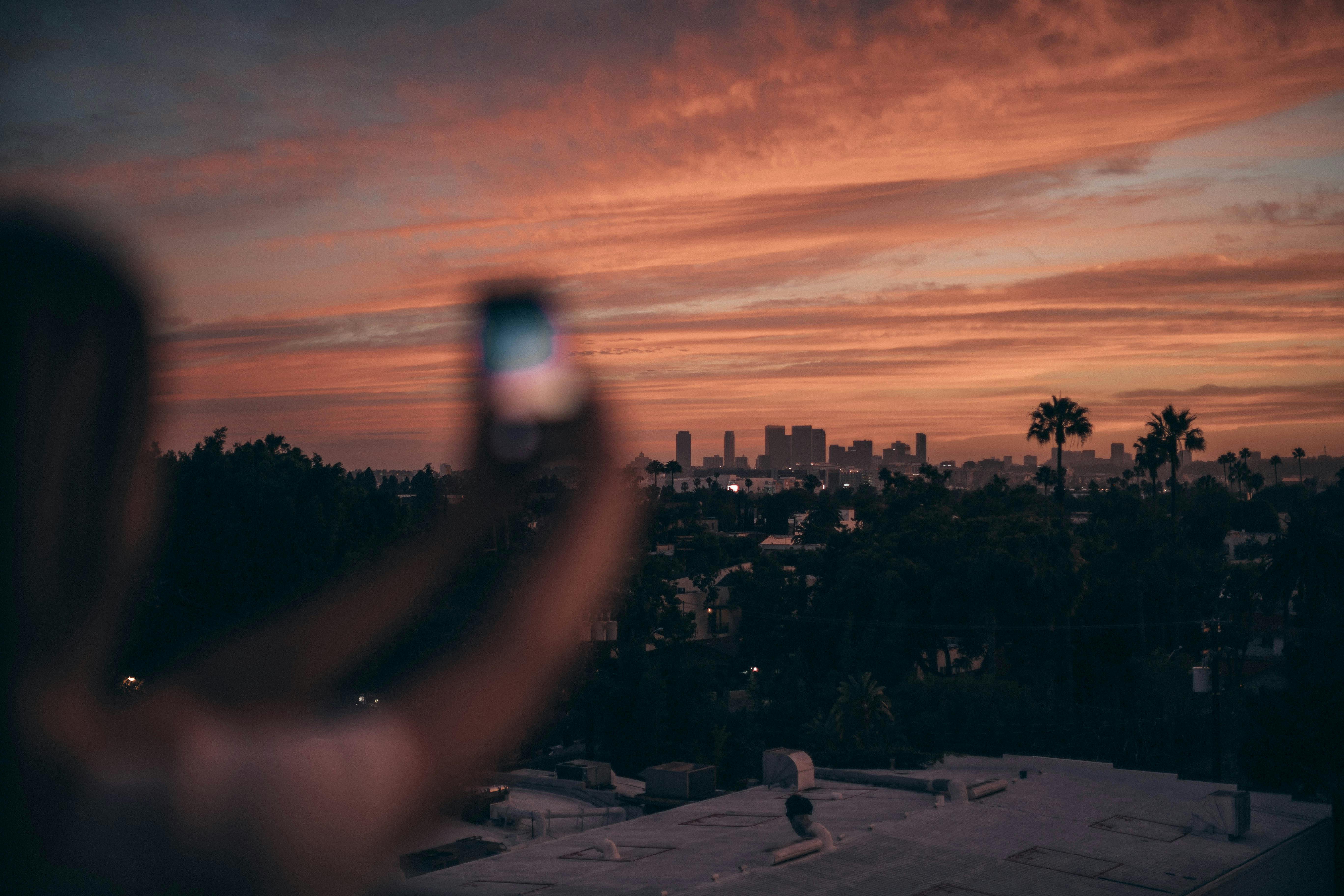 photo of person taking pictures during dawn