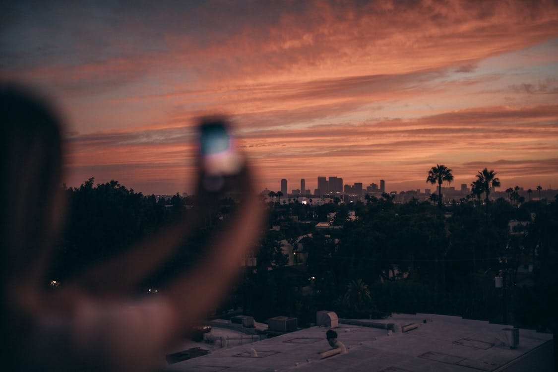 Photo Of Person Taking Pictures During Dawn