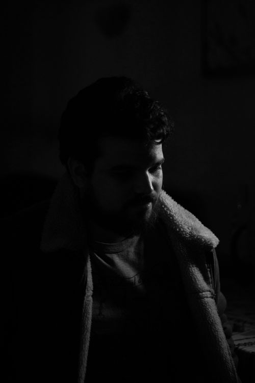 Free A dramatic black and white portrait of a man with a beard in a cozy jacket. Stock Photo