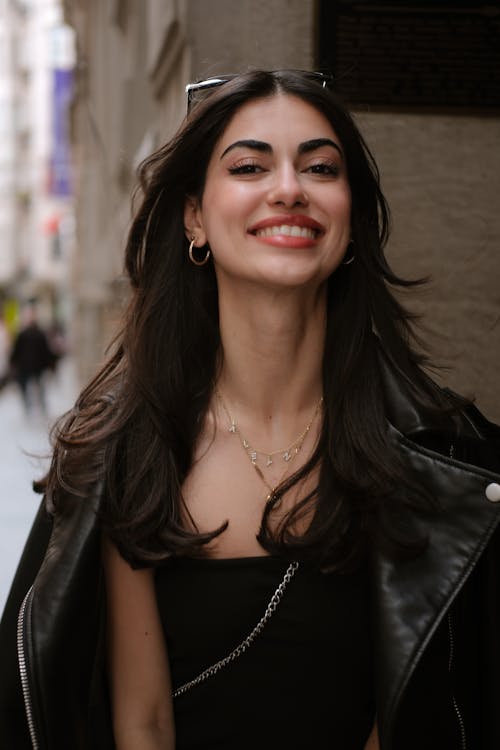 A woman in a black leather jacket smiling