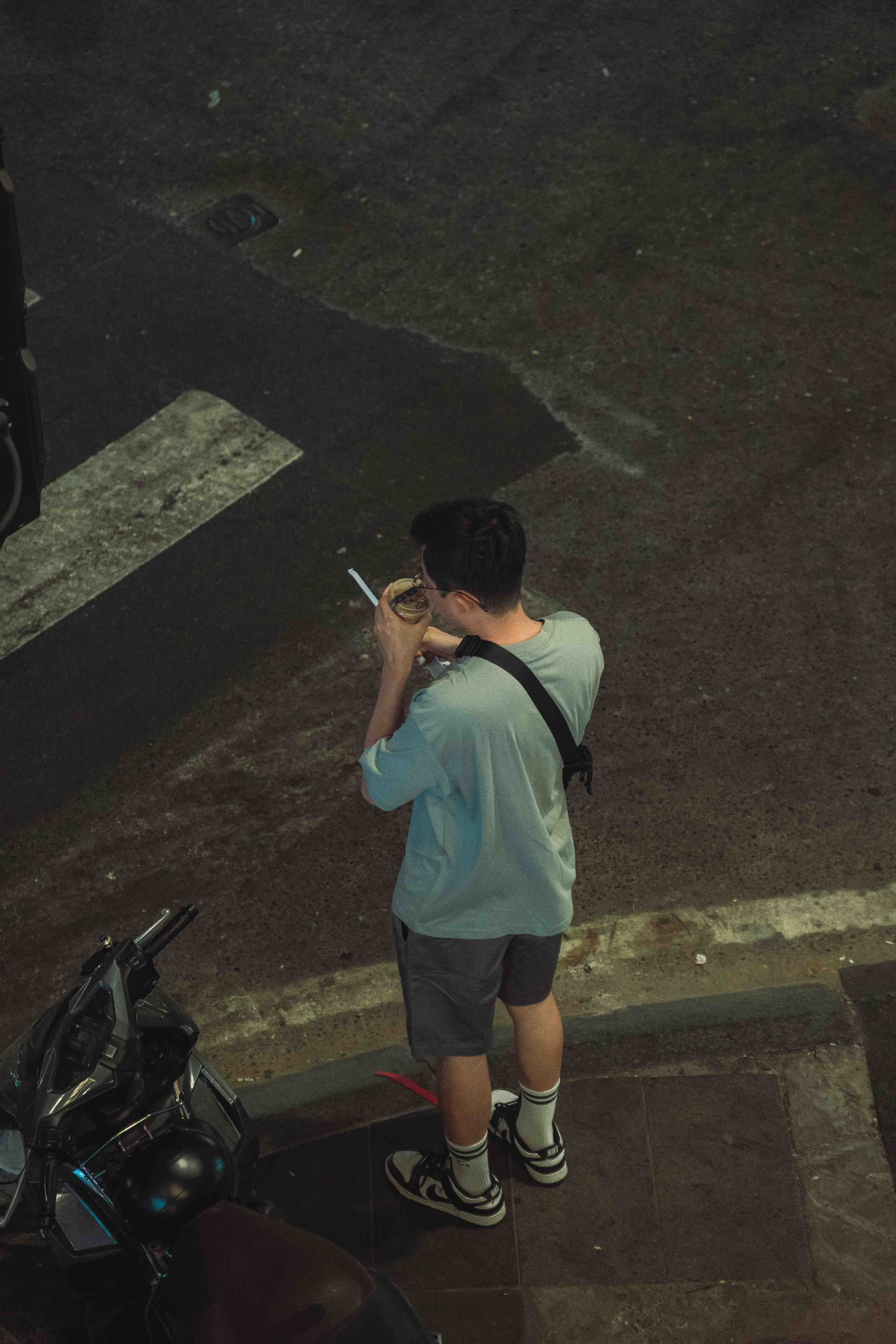 Man Drinking Coffee on the Sidewalk