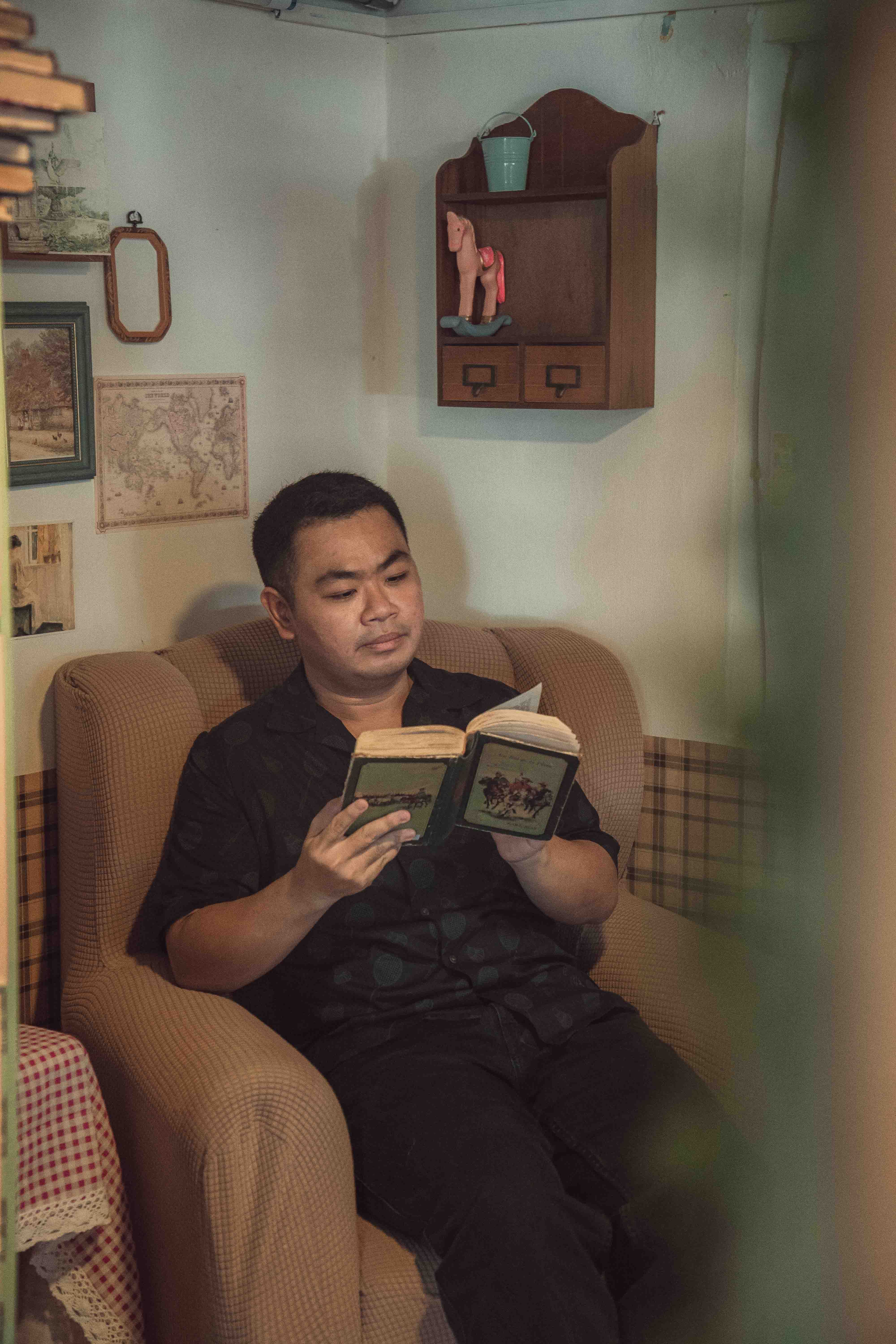 Relaxing in a cozy chair with a book, capturing a peaceful moment in Ho Chi Minh City.