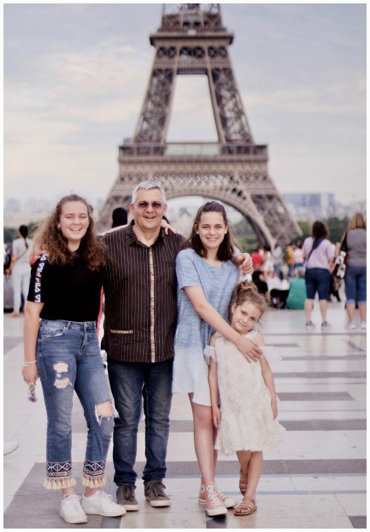 Family Taking Photo Near Eiffel Tower