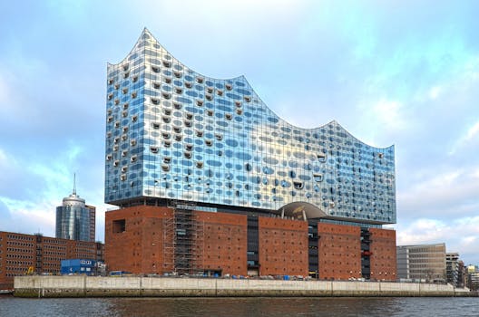 Stunning view of the Elbphilharmonie concert hall reflecting the sky on the Elbe River. by Pixabay