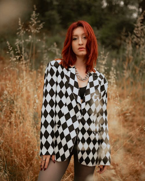 A woman in a black and white checkered jacket