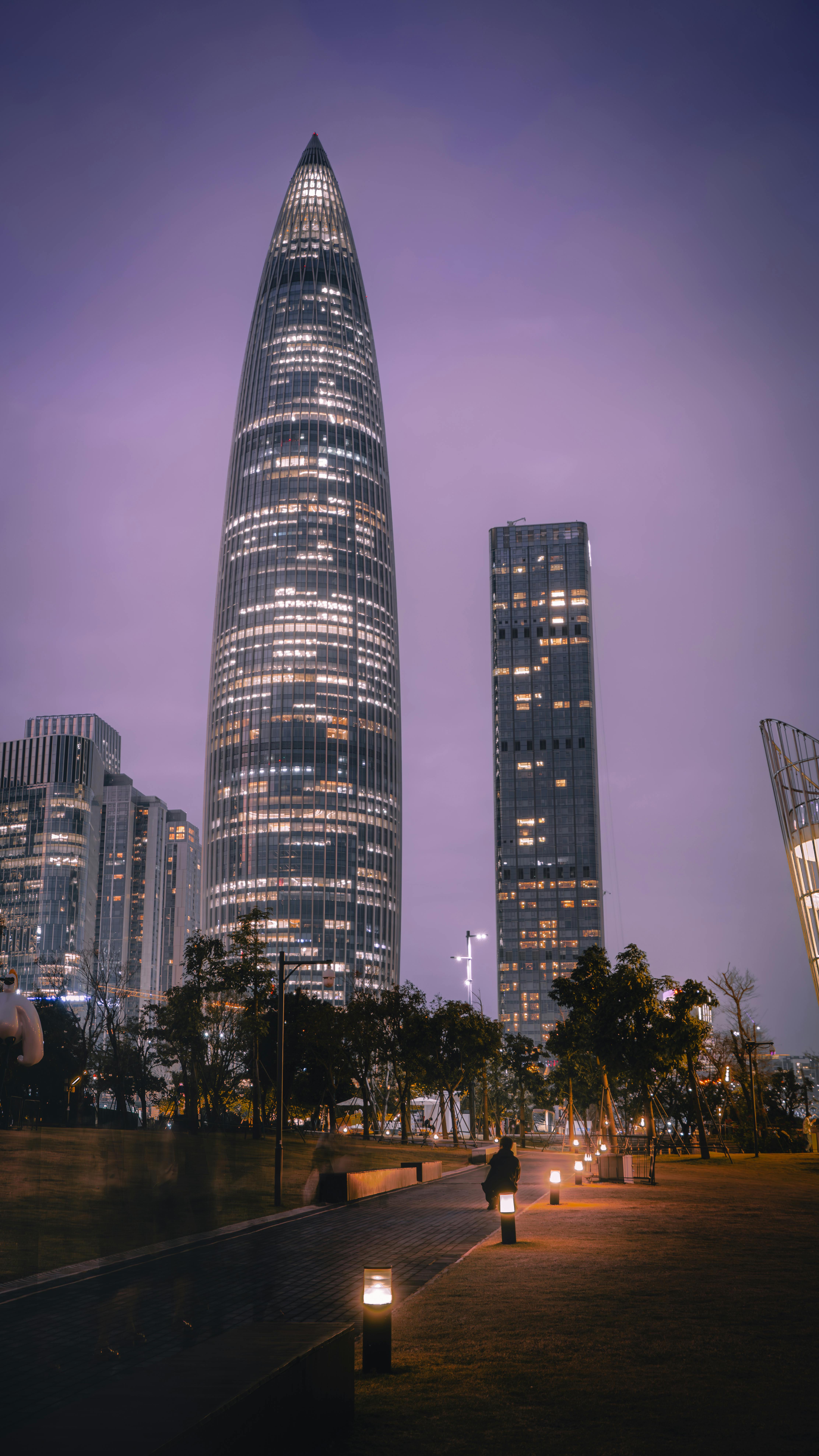 Tall Illuminated Rocket Like Skyscraper in City · Free Stock Photo