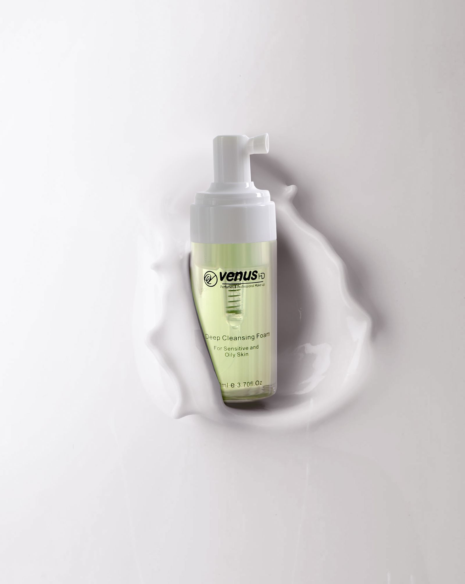 Foaming facial cleanser bottle displayed against a smooth background without people