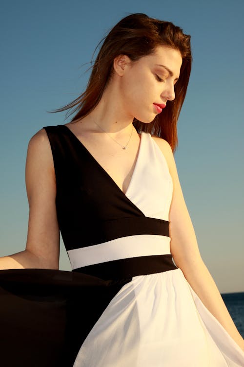 Photo of a Woman in Black and White Sleeveless Dress