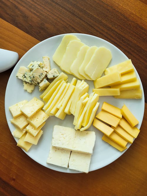 A plate of cheese and other food items on a table