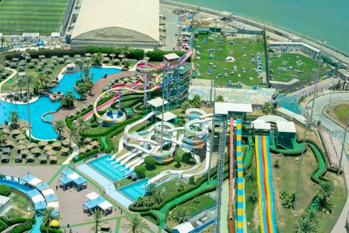 Free Capture the excitement of a vibrant water park from above, showcasing colorful slides and pools. Stock Photo