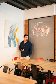 Trendy restaurant interior featuring neon sign and colorful artwork with a casual vibe.