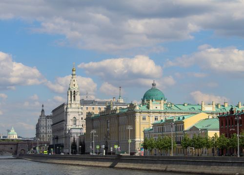 Free View of iconic buildings along the Moscow River under a bright sky. Stock Photo