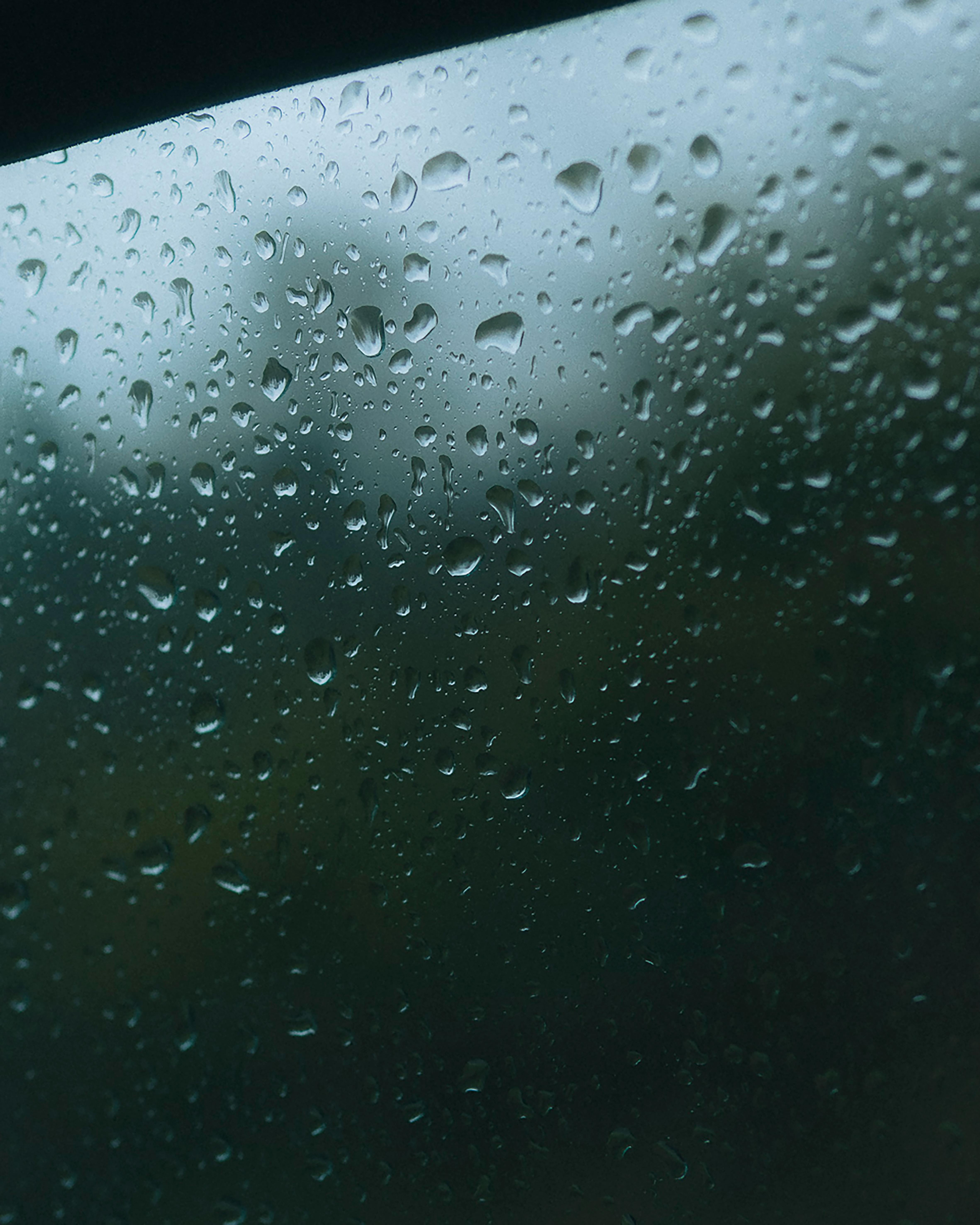 View through a rain-covered window in Bilbao, capturing serene raindrops and reflections.