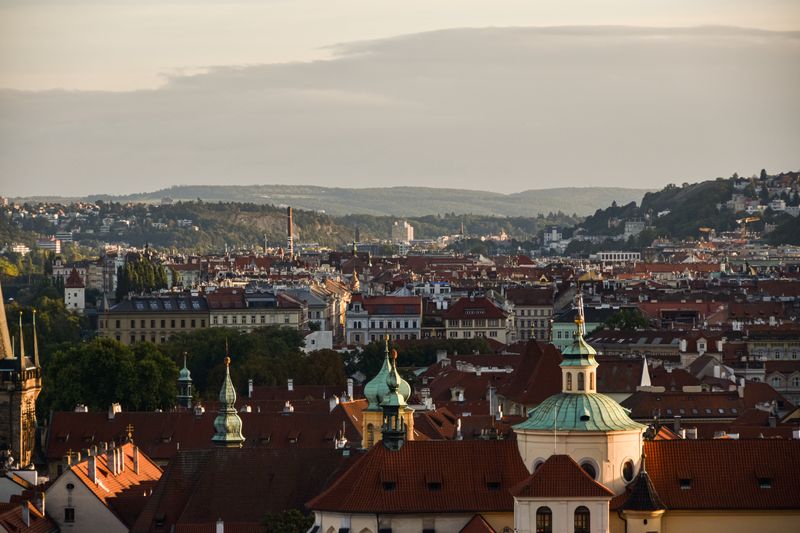 Stunning aerial view of Prague's historic cityscape at sunset, showcasing iconic architecture.