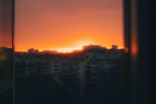 A stunning view of a golden sunset casting silhouettes over Stockholm's cityscape.