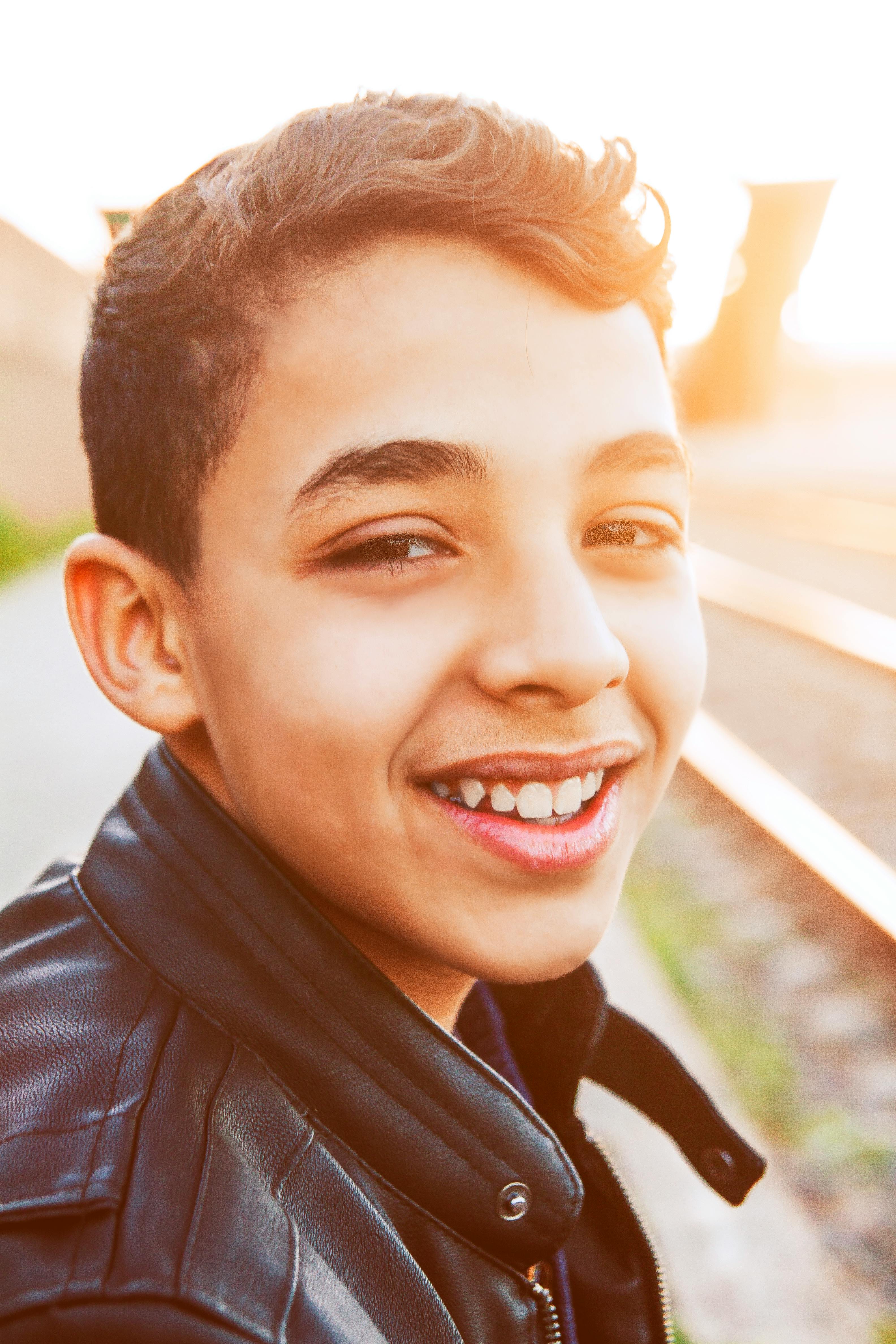 photo of boy wearing black leather jacket