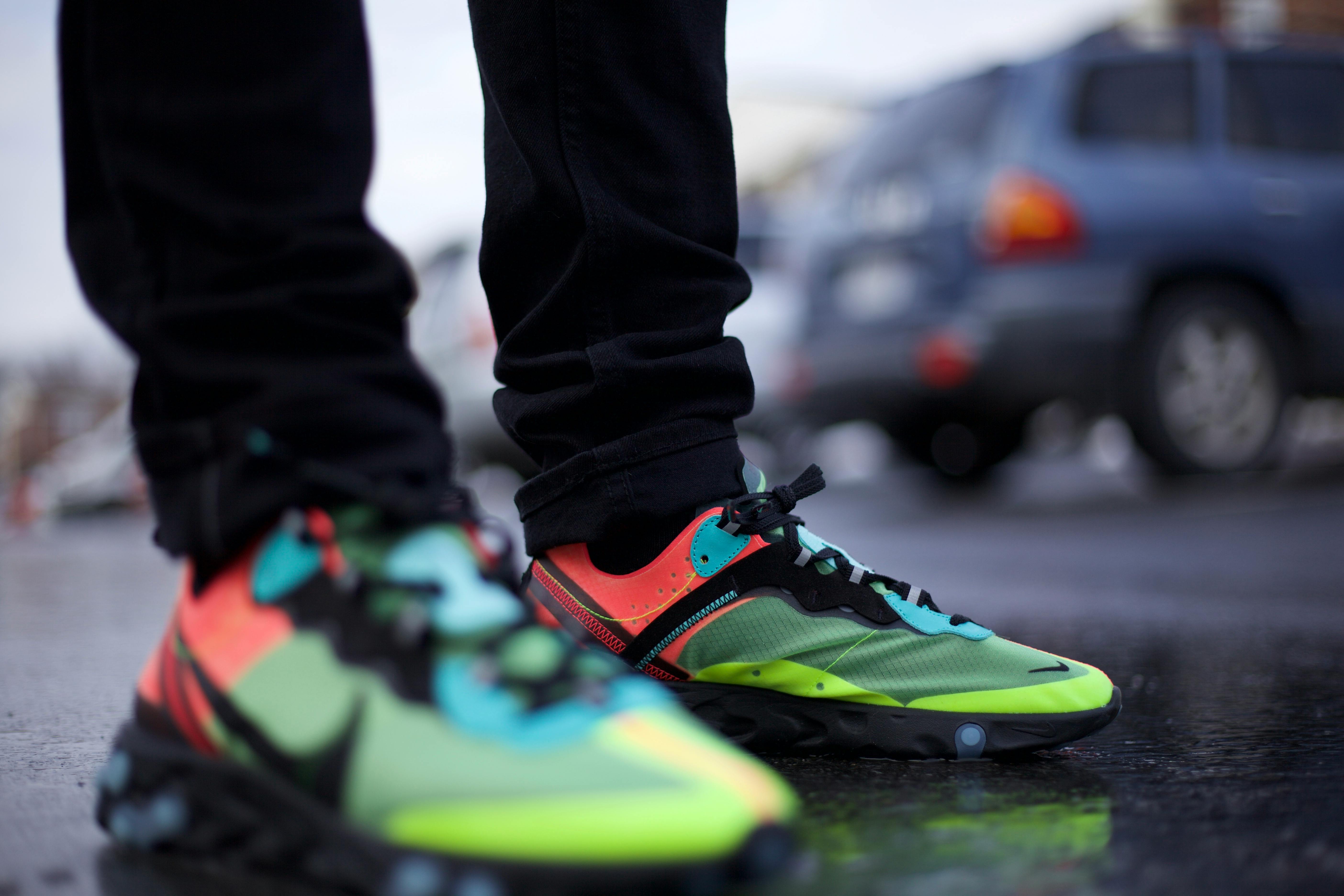 selective focus photo of person wearing sneakers