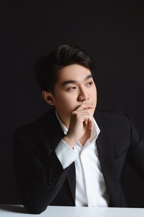 Free Elegant portrait of a young Asian man in a suit against a dark background, captured in Thành phố Hồ Chí Minh. Stock Photo