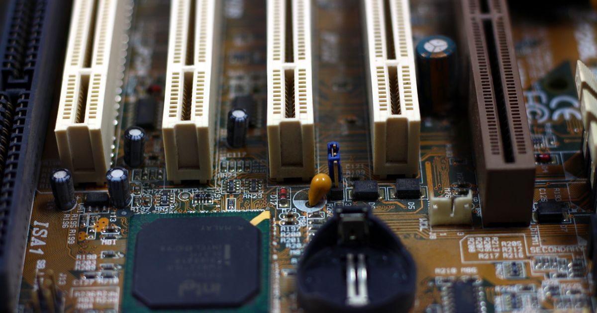 A computer motherboard showing memory slots and components.