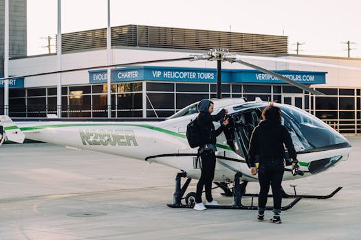 Two individuals getting into a helicopter at an airport's charter service area.