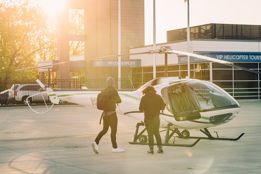 Two adults prepare a light helicopter for flight at a sunlit helipad, capturing aviation moments.