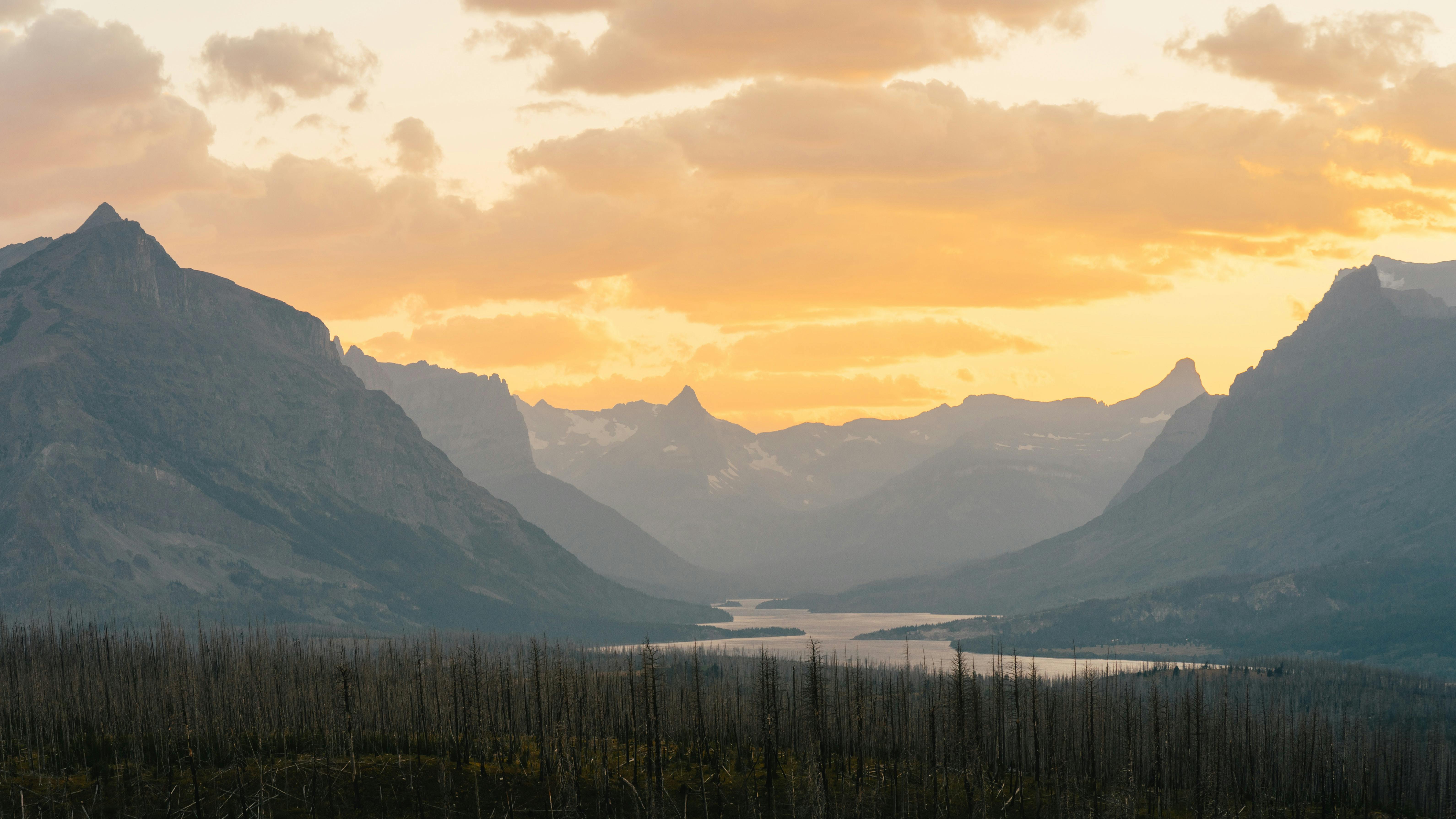 silhouette of mountains under golden sky