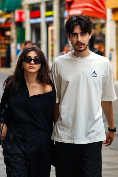 Free Fashionable couple strolling in the city, showcasing trendy clothing and accessories. Stock Photo