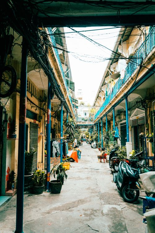 Free Explore a vibrant narrow alleyway in Ho Chi Minh City with motorbikes and local life. Stock Photo