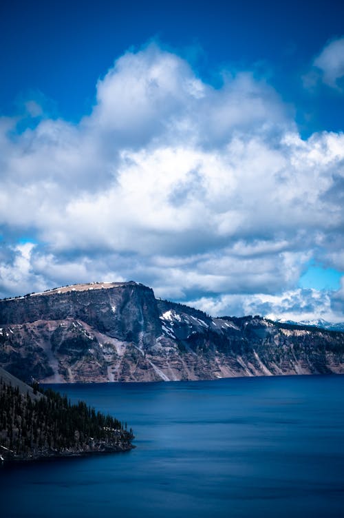 Free Scenic View Of Cliff Under Cloudy Sky Stock Photo