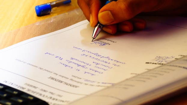 Person Holding Silver Pen Signing Photographers Signature 