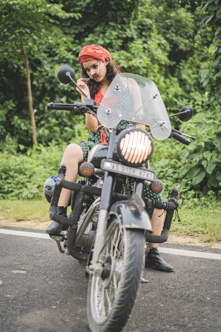 Young Woman Sitting On A Cruiser Motorcycle