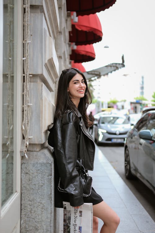 A woman in a black leather jacket and black boots