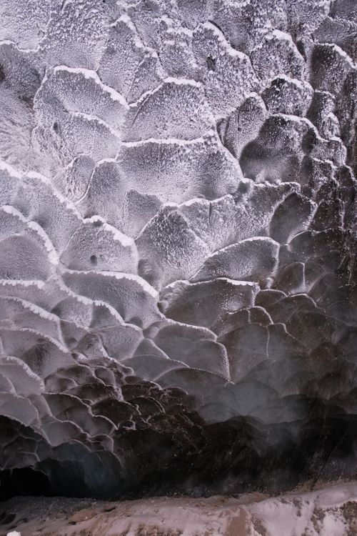 Free Close-up of a frozen surface showcasing intricate wavy ice patterns and textures. Stock Photo