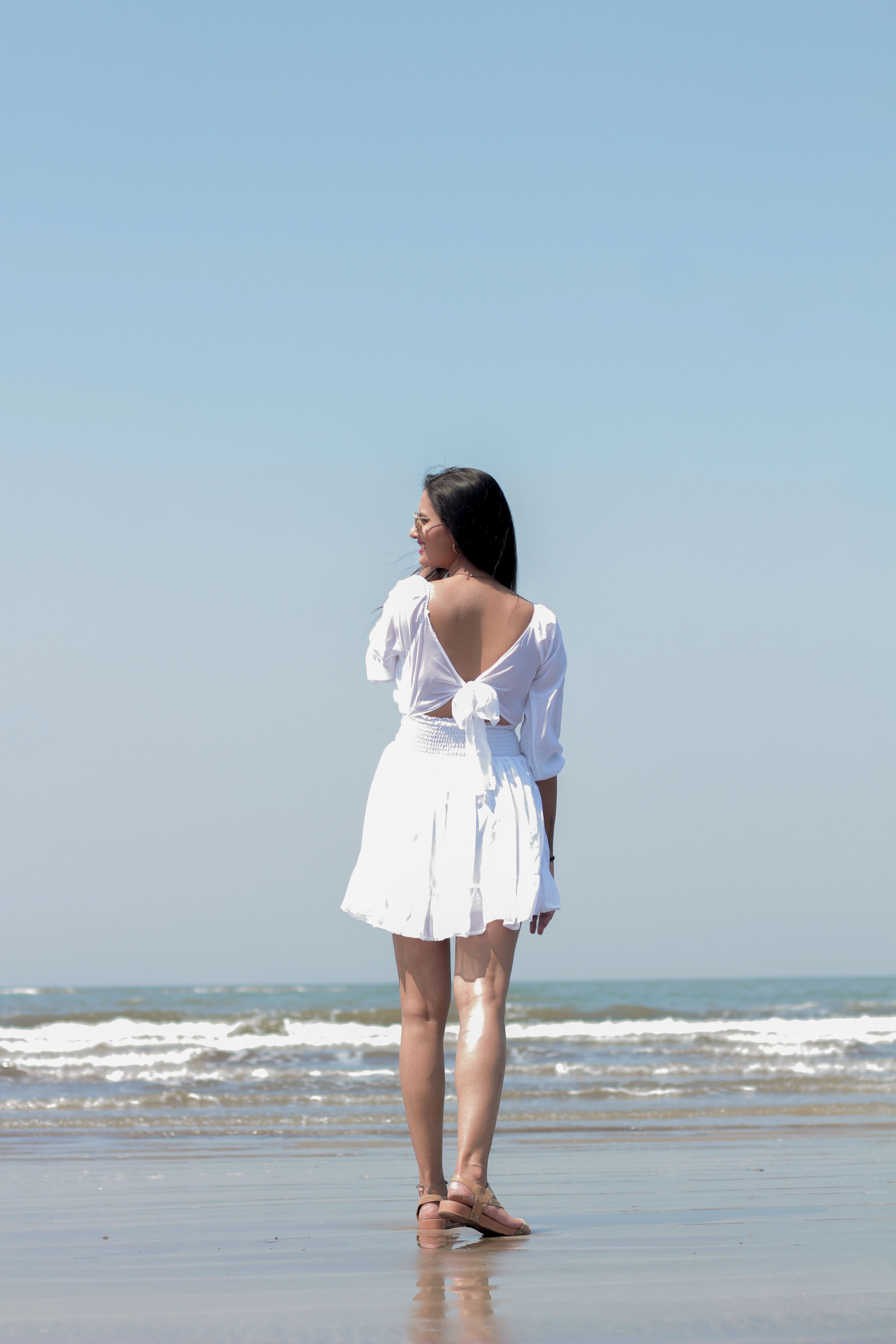 Back View of a Woman in a White Dress Standing on the Beach · Free ...
