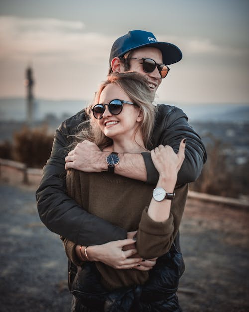 Selective Focus Photo of Hugging Couple Posing
